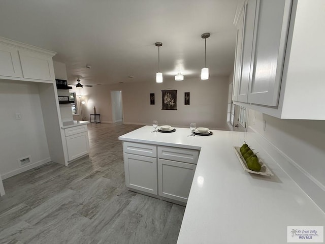 kitchen featuring ceiling fan, light hardwood / wood-style flooring, white cabinets, and decorative light fixtures