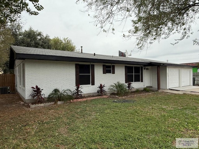 single story home featuring a garage, central air condition unit, and a front yard