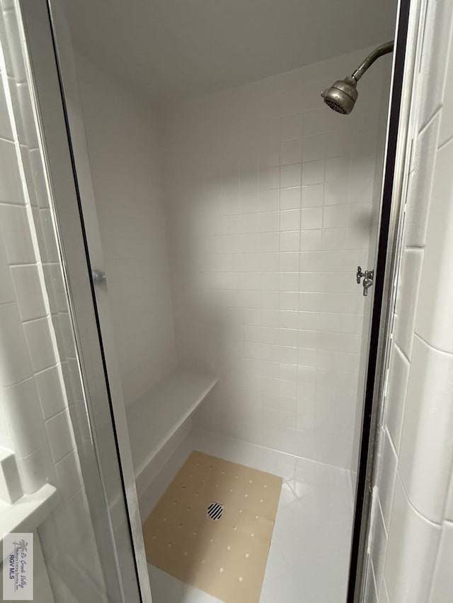 bathroom with tiled shower