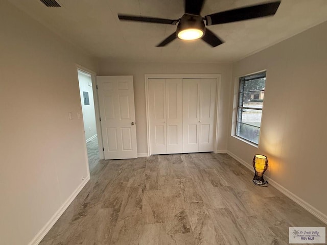 unfurnished bedroom with a closet, ceiling fan, and light hardwood / wood-style floors