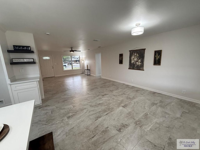 unfurnished living room featuring ceiling fan