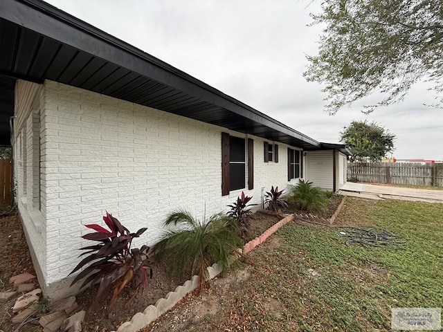 view of side of property with a lawn