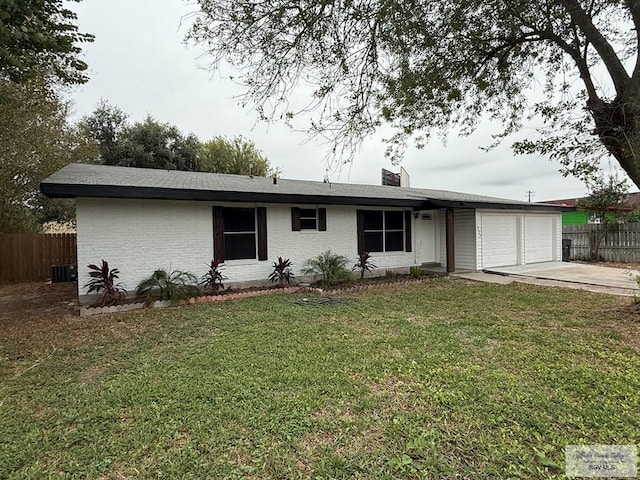 ranch-style house with central AC, a garage, and a front lawn