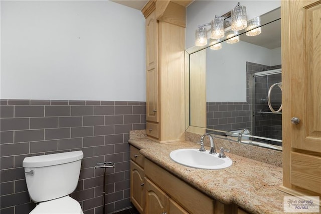 1500 Bryan Rd, Mission, TX 78572 - bathroom featuring vanity, tile walls, a tile shower, and wainscoting