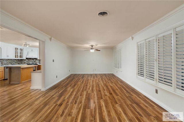 1500 Bryan Rd, Mission, TX 78572 - unfurnished living room featuring ceiling fan, wood finished floors, and ornamental molding