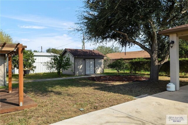 1500 Bryan Rd, Mission, TX 78572 - view of grassy yard with a storage unit and a patio area