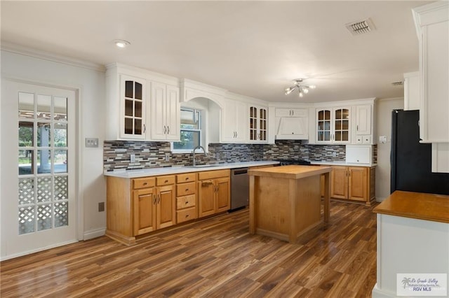 1500 Bryan Rd, Mission, TX 78572 - kitchen with freestanding refrigerator, extractor fan, wood counters, dishwasher, and dark wood-style flooring