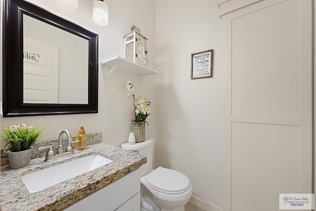 bathroom with vanity and toilet