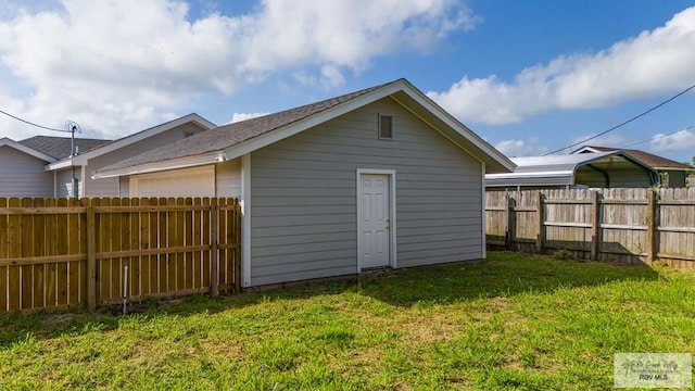 view of outbuilding with a yard