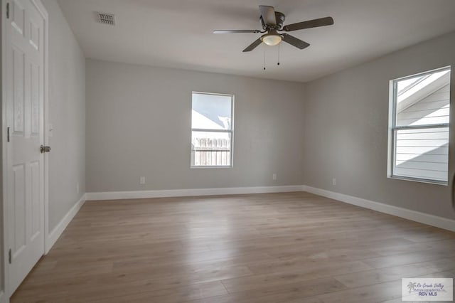 spare room with ceiling fan and light wood-type flooring