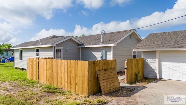 rear view of house with a garage