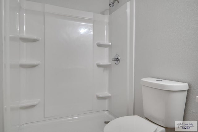 bathroom with toilet and a shower