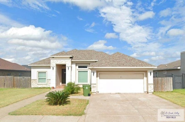 prairie-style home featuring a garage and a front lawn