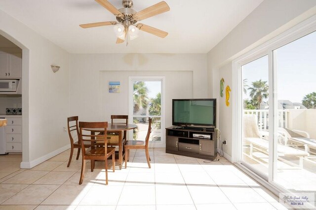 6401 Fountain Way S, Padre Island, TX 78597 - dining space with light tile patterned flooring, arched walkways, and ceiling fan