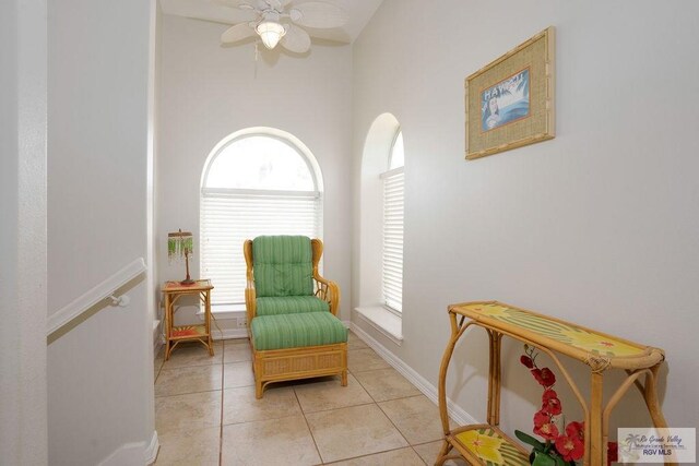 6401 Fountain Way S, Padre Island, TX 78597 - living area featuring light tile patterned flooring, plenty of natural light, and a ceiling fan