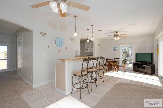 6401 Fountain Way S, Padre Island, TX 78597 - kitchen with a ceiling fan, white microwave, plenty of natural light, and arched walkways