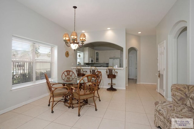 6401 Fountain Way S, Padre Island, TX 78597 - dining space with arched walkways, light tile patterned floors, a chandelier, and recessed lighting