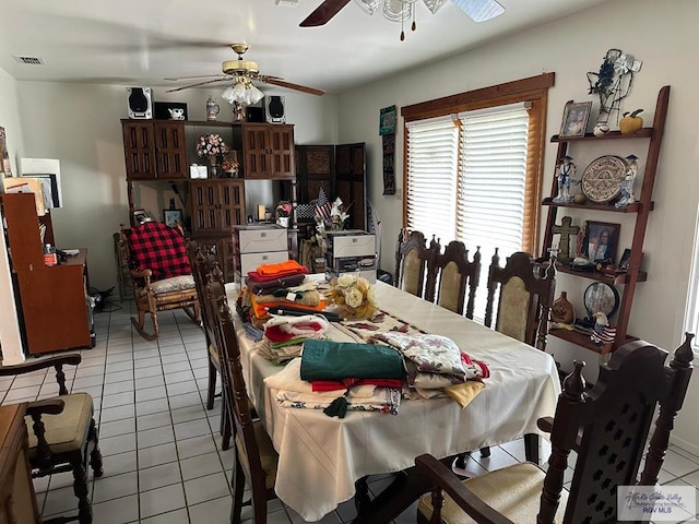 dining space featuring ceiling fan and light tile patterned floors