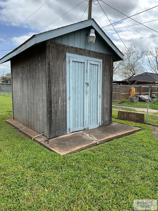 view of outbuilding featuring a lawn