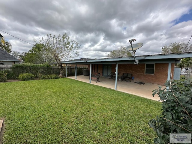 rear view of house with a patio and a lawn