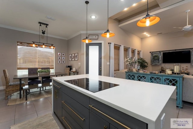 kitchen featuring black electric cooktop, a center island, light tile patterned flooring, and open floor plan