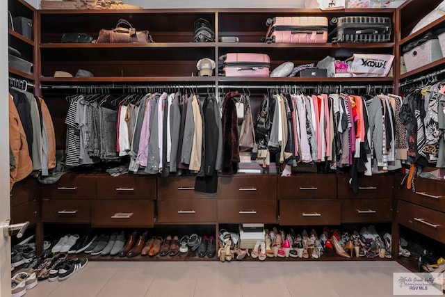 walk in closet with tile patterned flooring