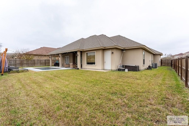 rear view of property featuring a yard, a patio, stucco siding, a fenced backyard, and cooling unit
