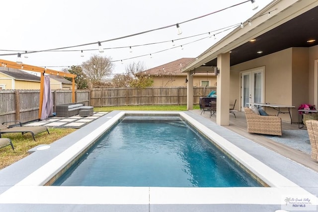 view of swimming pool with a fenced backyard, a patio, and french doors