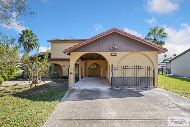 mediterranean / spanish-style home with a front yard