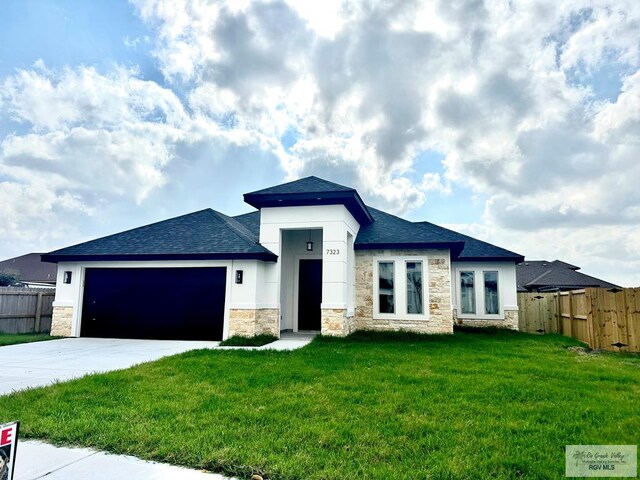 view of front of home featuring a front lawn and a garage