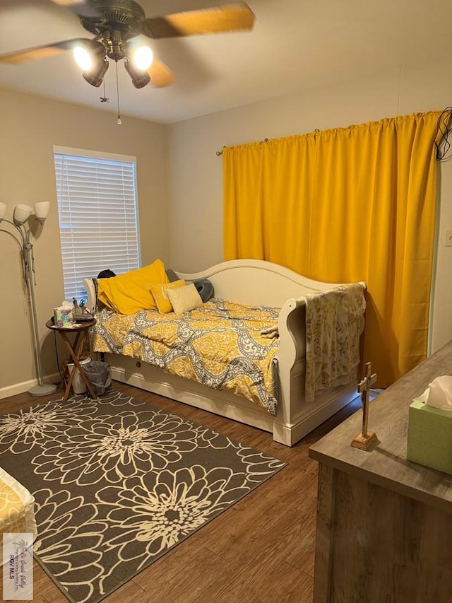 bedroom with ceiling fan and dark hardwood / wood-style floors