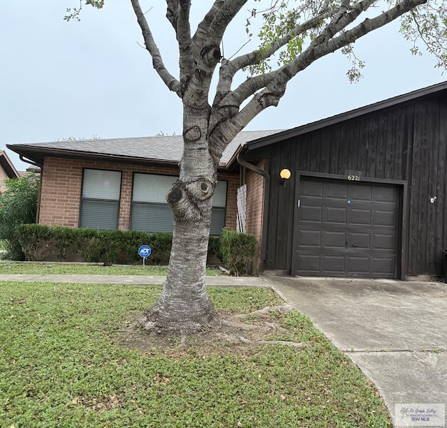 ranch-style home with a front yard and a garage