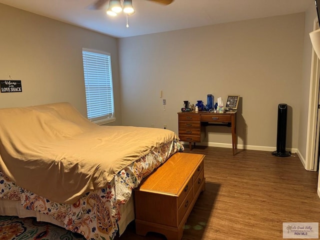 bedroom with ceiling fan and dark hardwood / wood-style floors