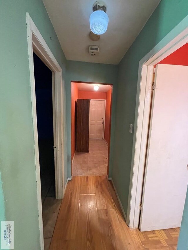 corridor with light wood-style floors