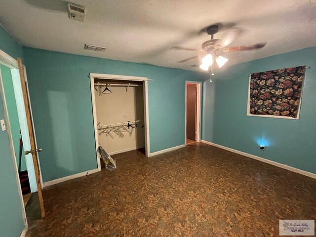 unfurnished bedroom featuring a closet, visible vents, ceiling fan, and baseboards