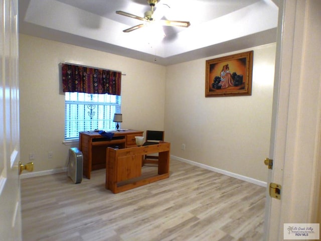 180 Chippewa Cir, Harlingen, TX 78555 - office area featuring light wood-type flooring, a tray ceiling, a ceiling fan, and baseboards