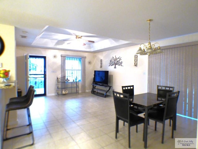 180 Chippewa Cir, Harlingen, TX 78555 - dining area featuring a raised ceiling, a chandelier, ceiling fan, and baseboards