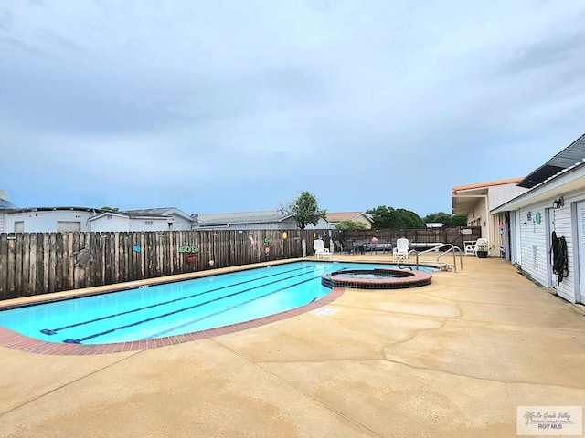 180 Chippewa Cir, Harlingen, TX 78555 - view of pool with a fenced backyard, a patio, and a pool with connected hot tub