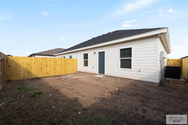 rear view of house with central AC unit