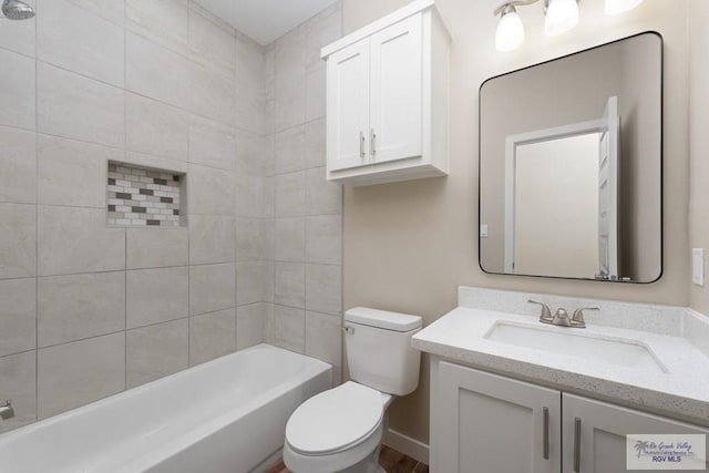 full bathroom with tiled shower / bath combo, vanity, and toilet