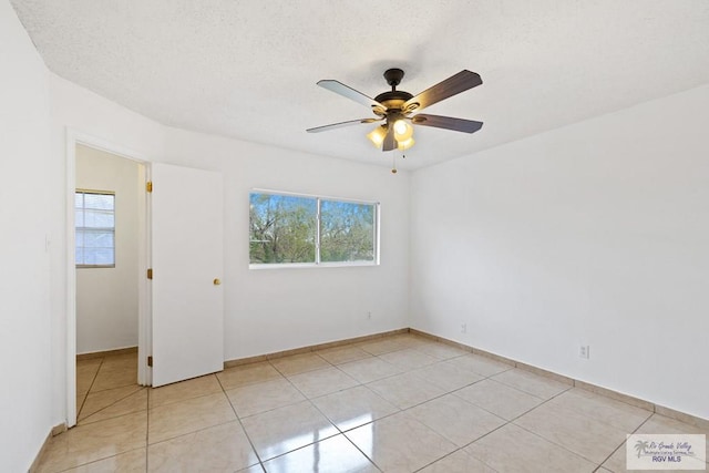 tiled empty room with ceiling fan