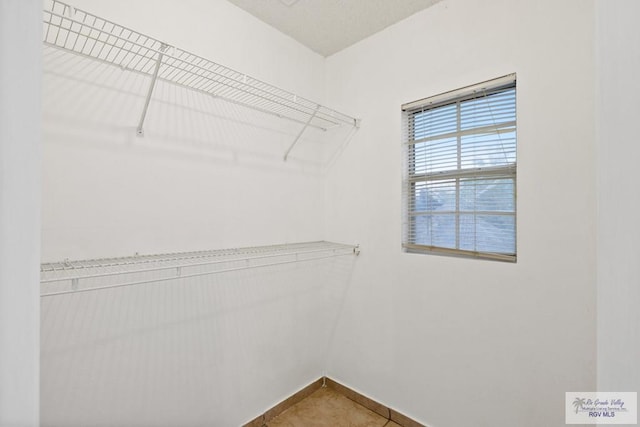 walk in closet featuring tile patterned flooring