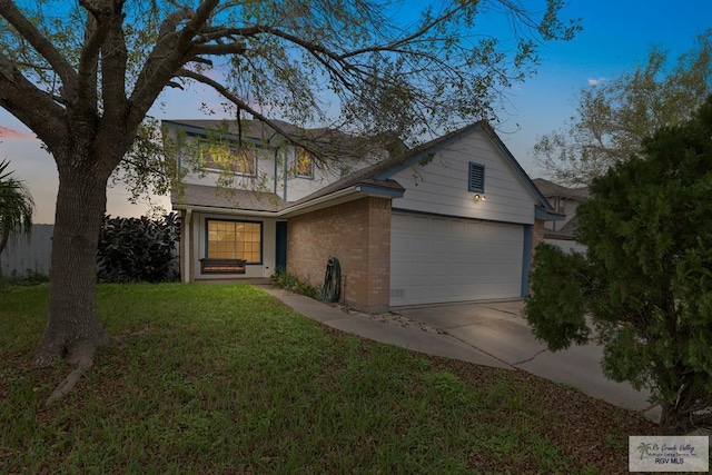 view of front of home with a garage and a lawn