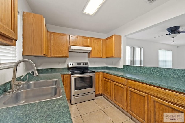 kitchen featuring electric stove, sink, light tile patterned floors, and ceiling fan