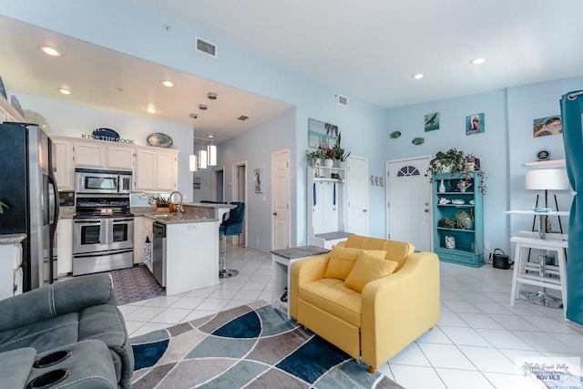 tiled living room featuring sink