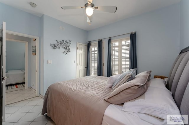 tiled bedroom featuring ceiling fan