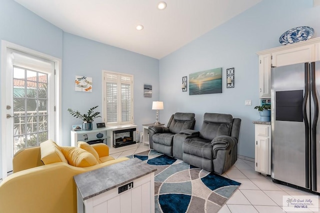 living room with light tile patterned floors and vaulted ceiling