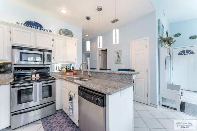 kitchen with white cabinets, sink, hanging light fixtures, kitchen peninsula, and stainless steel appliances