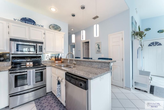 kitchen featuring sink, kitchen peninsula, decorative light fixtures, white cabinets, and appliances with stainless steel finishes