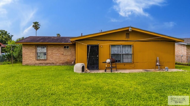 24 Ivy Ln, Brownsville, TX 78521 - rear view of property featuring a yard and a patio
